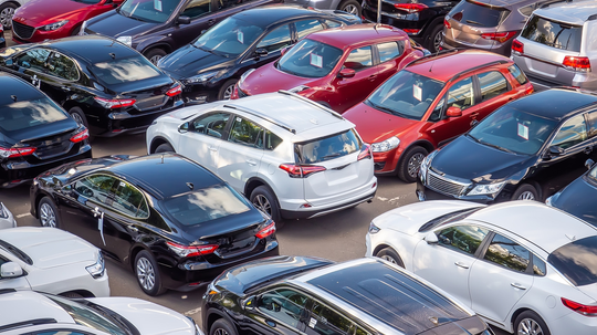 New road vehicles parked in a car park